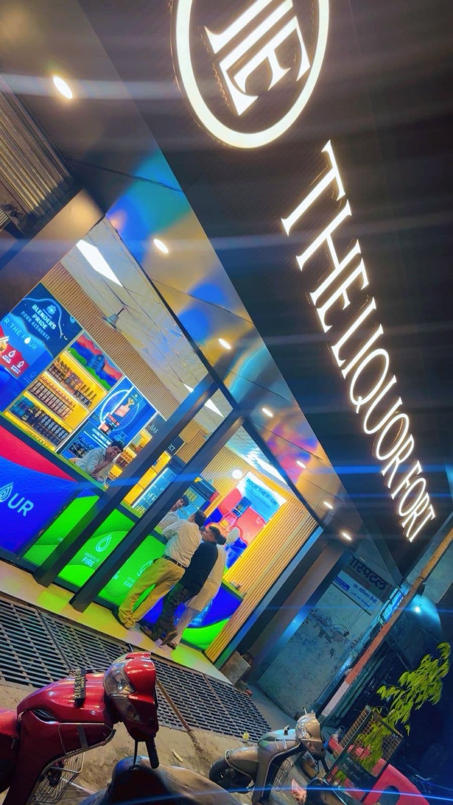 Beer, rum, and whisky bottles displayed inside daaru shop in Uttar Pradesh