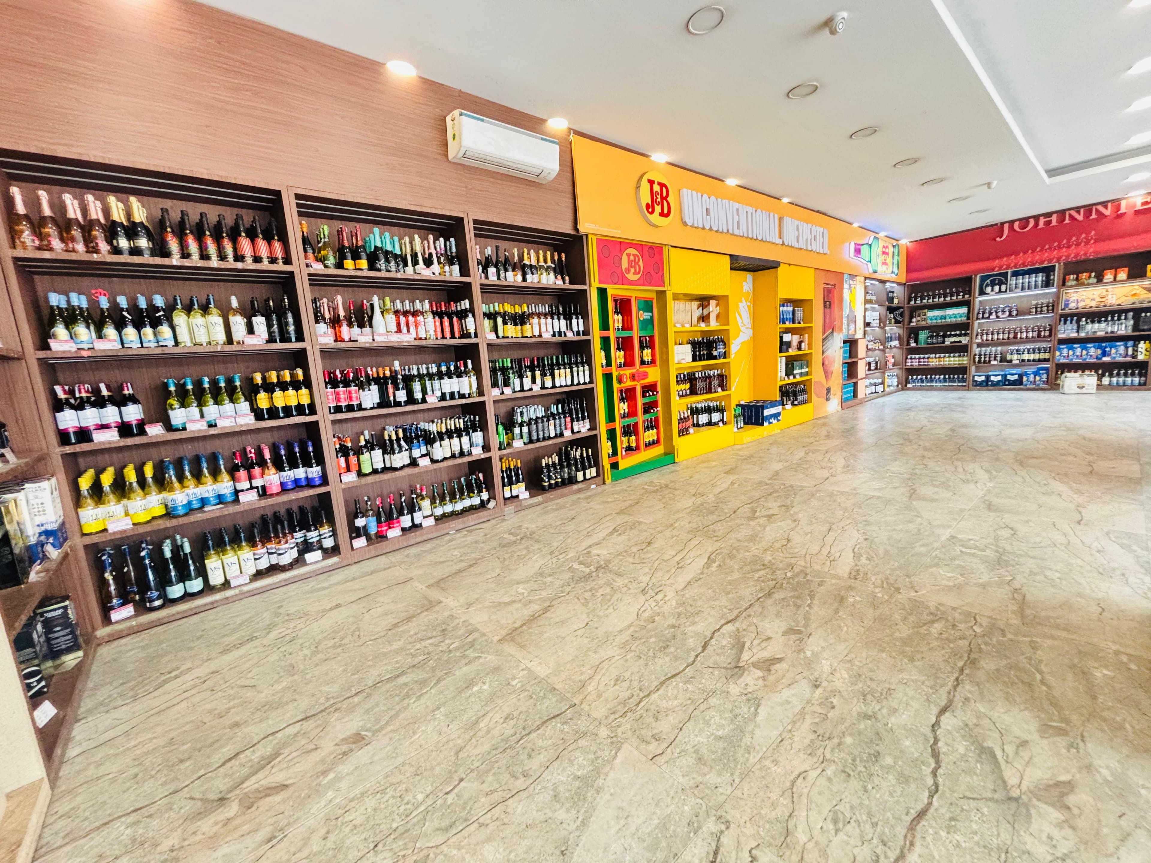 Liquor shelves at G-Town Wines Kasan Gurgaon displaying daru, sharab bottles, Old Monk, brandy, gin,