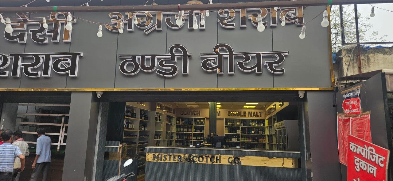 Beer crates stacked behind the liquor counter in Noida