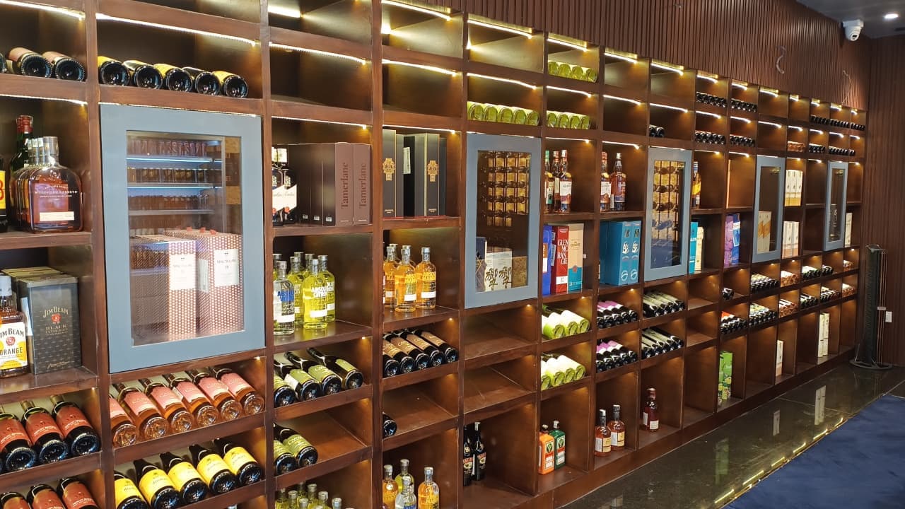 Customer browsing fine spirits in Ufairia Mall Noida liquor store