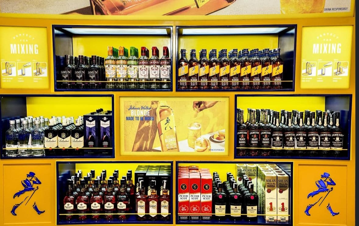 Elegant alcohol store with warm lighting and organized shelves.